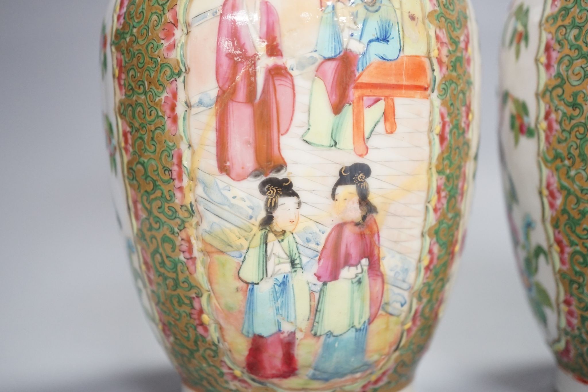 A pair of 19th century Chinese famille rose vases, 24 cms high.